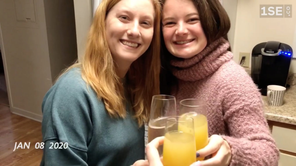 2 girls drinking orange juice